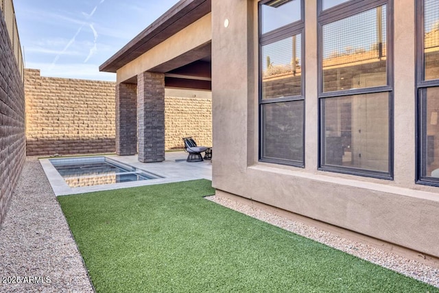 view of yard with a patio area, a fenced in pool, and fence