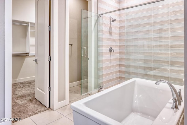 full bathroom featuring tile patterned floors, a stall shower, and a garden tub