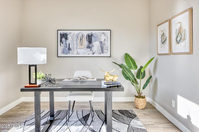 home office with wood finished floors and baseboards