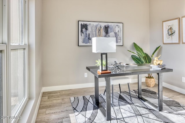 office space with baseboards and wood finished floors