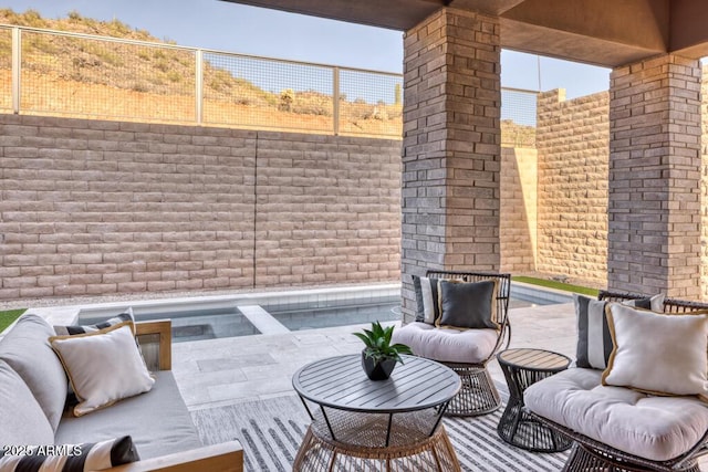 view of patio / terrace with fence and an outdoor hangout area