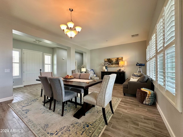 dining area featuring a chandelier and hardwood / wood-style floors