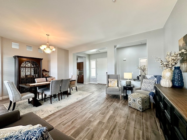 living room with hardwood / wood-style flooring and an inviting chandelier