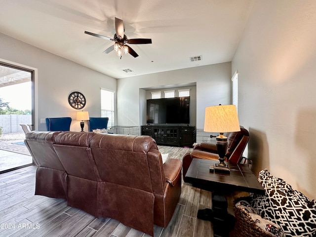 living room with hardwood / wood-style flooring and ceiling fan