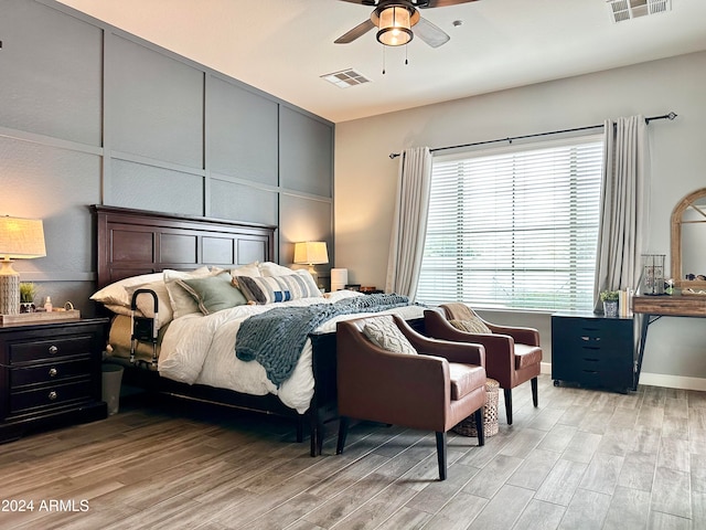 bedroom featuring light hardwood / wood-style floors and ceiling fan