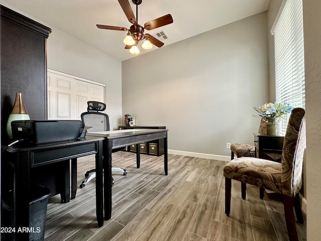 office featuring ceiling fan, hardwood / wood-style floors, and vaulted ceiling