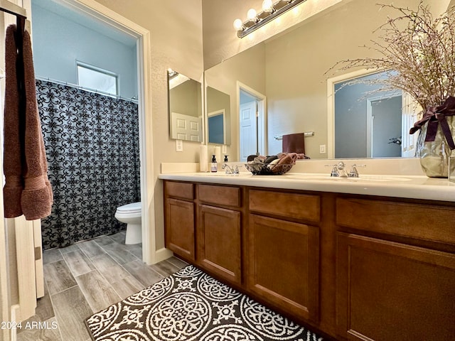 bathroom with hardwood / wood-style flooring, vanity, and toilet