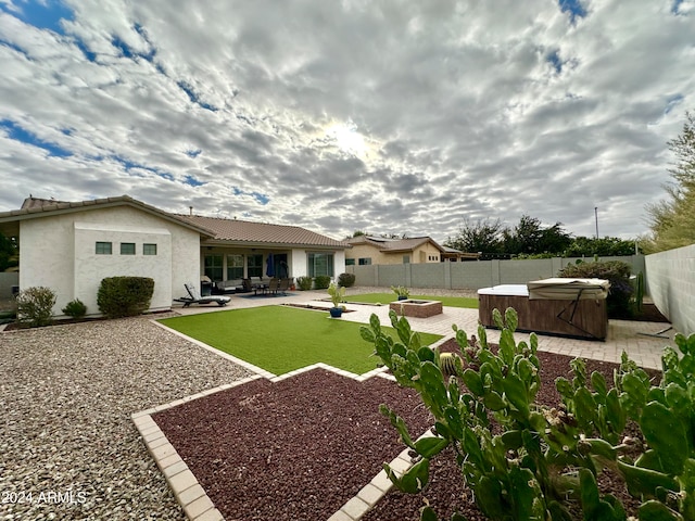 view of yard with a patio and a hot tub