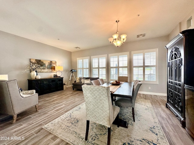 dining room featuring a chandelier and light hardwood / wood-style floors