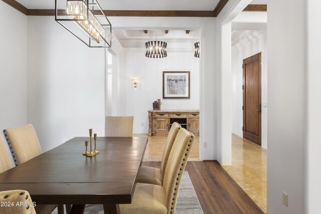 kitchen featuring light stone countertops, stove, crown molding, sink, and hanging light fixtures