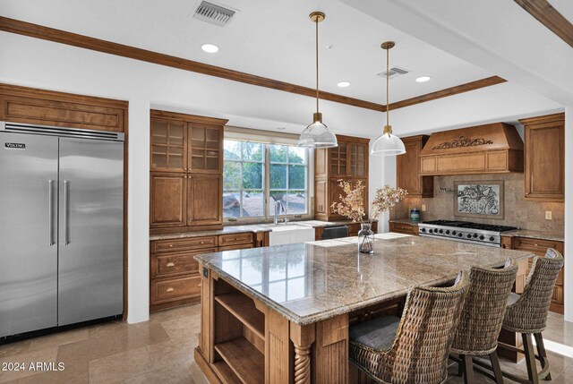 kitchen featuring custom exhaust hood, decorative backsplash, built in microwave, stainless steel range, and a kitchen island