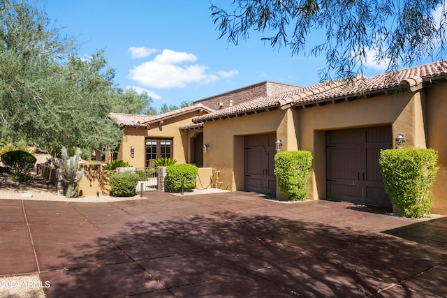 mediterranean / spanish house with a garage