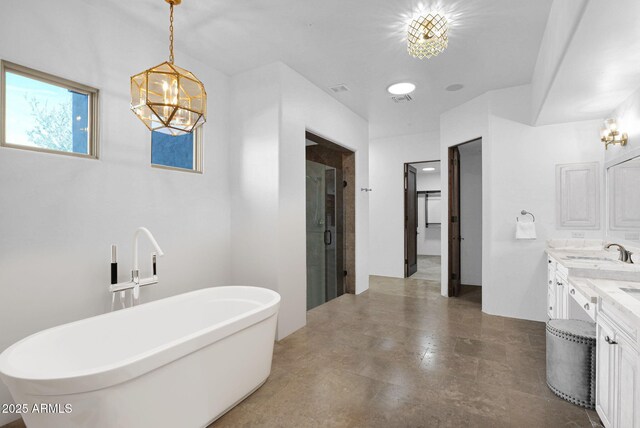 washroom with washer and clothes dryer, cabinets, and sink