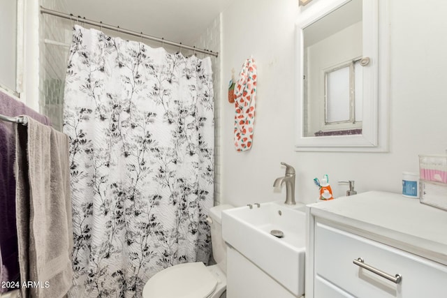 bathroom with vanity, toilet, and curtained shower