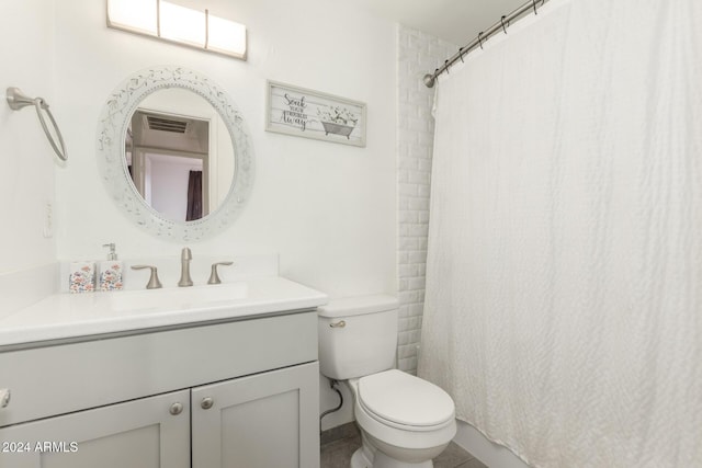 bathroom with vanity, toilet, and curtained shower