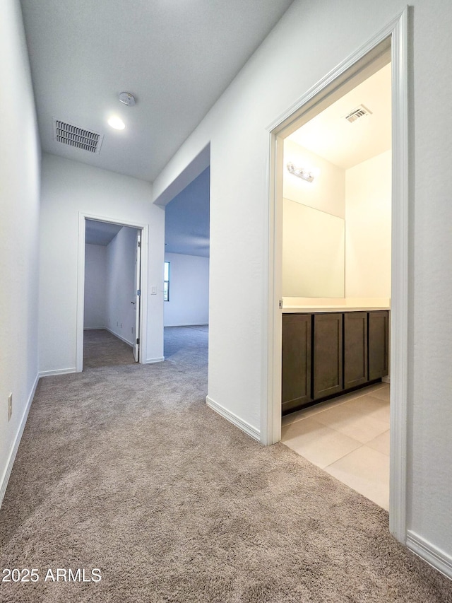 19954 W Moonlight Path, Buckeye, AZ 85326 - corridor featuring light colored carpet and baseboards