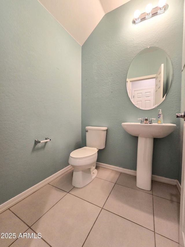 19954 W Moonlight Path, Buckeye, AZ 85326 - half bath featuring lofted ceiling, toilet, tile patterned flooring, and baseboards