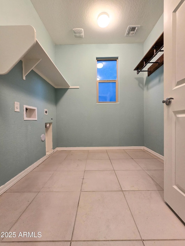 19954 W Moonlight Path, Buckeye, AZ 85326 - laundry room featuring electric dryer hookup, a textured ceiling, hookup for a gas dryer, washer hookup, and baseboards
