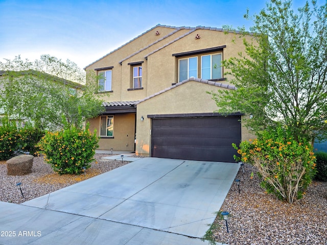 19954 W Moonlight Path, Buckeye, AZ 85326 - view of front facade featuring a tiled roof, stucco siding, and driveway