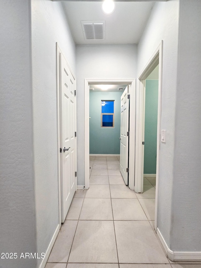 19954 W Moonlight Path, Buckeye, AZ 85326 - hallway with baseboards and light tile patterned floors