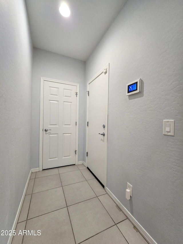 19954 W Moonlight Path, Buckeye, AZ 85326 - entryway with light tile patterned floors and baseboards