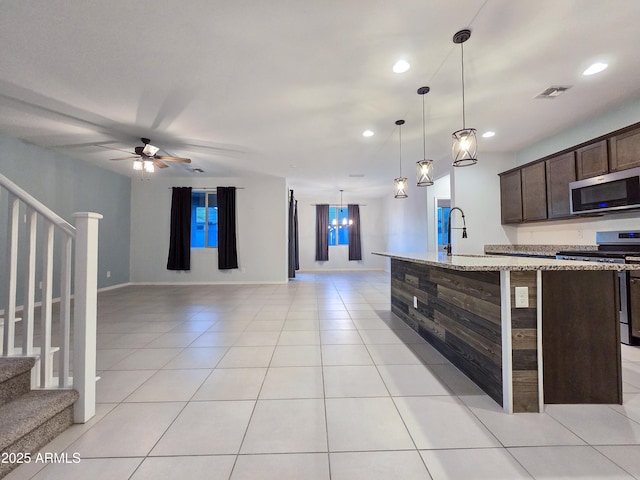 19954 W Moonlight Path, Buckeye, AZ 85326 - kitchen featuring appliances with stainless steel finishes, dark brown cabinetry, recessed lighting, a ceiling fan, and light tile patterned floors