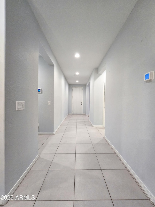 19954 W Moonlight Path, Buckeye, AZ 85326 - corridor featuring recessed lighting, light tile patterned floors, and baseboards