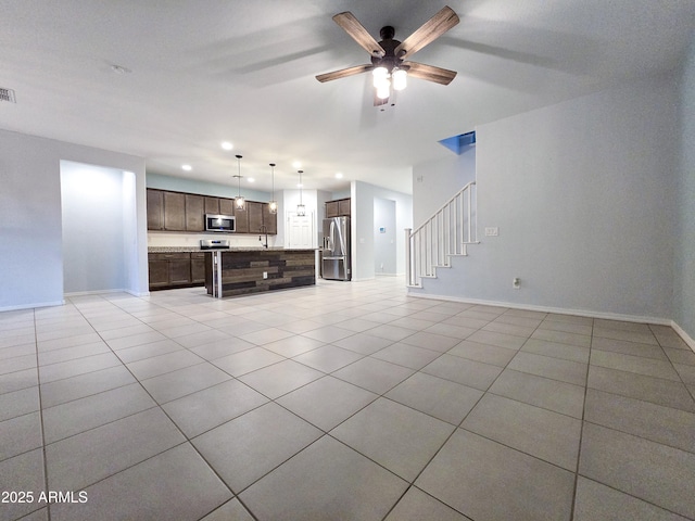 19954 W Moonlight Path, Buckeye, AZ 85326 - living area with light tile patterned flooring, ceiling fan, baseboards, and stairway