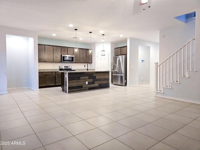 19954 W Moonlight Path, Buckeye, AZ 85326 - kitchen featuring stainless steel appliances, a sink, dark brown cabinetry, recessed lighting, and open floor plan