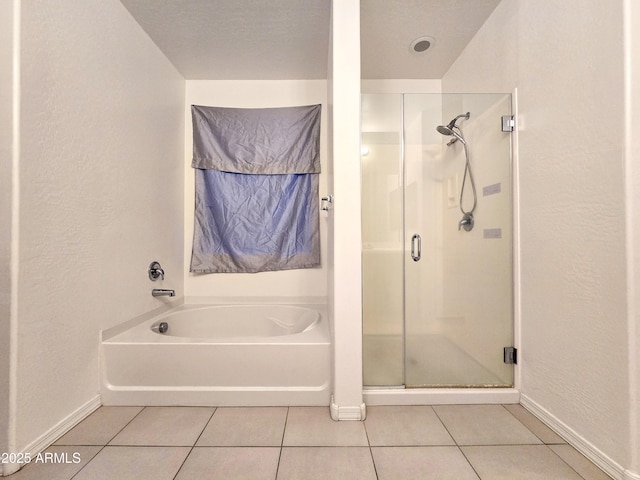 19954 W Moonlight Path, Buckeye, AZ 85326 - full bath with tile patterned flooring, a stall shower, baseboards, a garden tub, and a textured wall