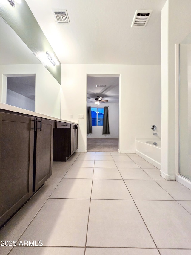 19954 W Moonlight Path, Buckeye, AZ 85326 - bathroom featuring tile patterned flooring, vanity, a bath, a ceiling fan, and a shower with door
