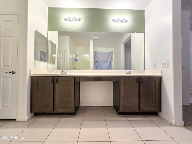 19954 W Moonlight Path, Buckeye, AZ 85326 - bathroom with double vanity, baseboards, and tile patterned flooring