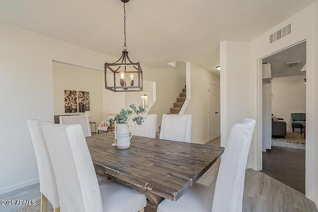 dining space with a notable chandelier and hardwood / wood-style flooring