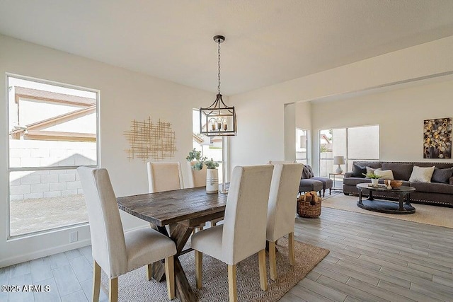 dining space featuring a chandelier and wood-type flooring