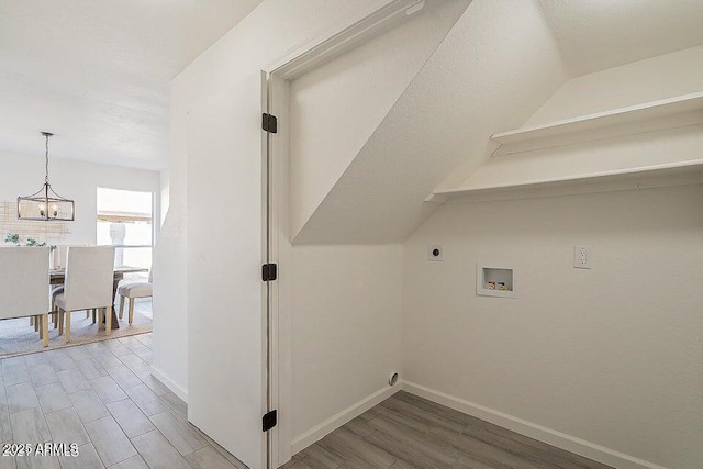 laundry room featuring washer hookup, electric dryer hookup, a chandelier, and hardwood / wood-style floors