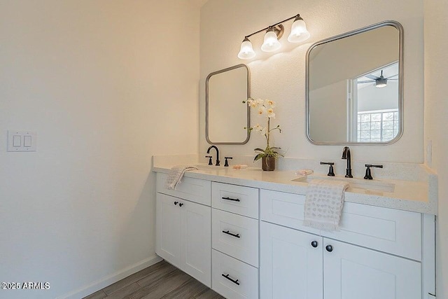 bathroom with hardwood / wood-style flooring, ceiling fan, and vanity