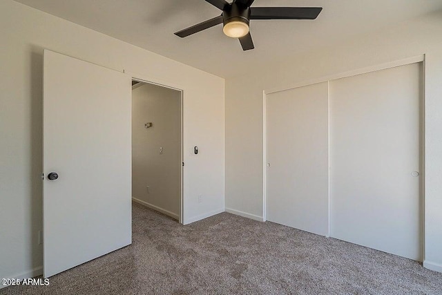 unfurnished bedroom with carpet floors, a closet, and ceiling fan