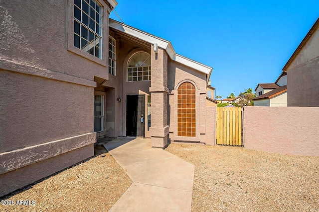 view of exterior entry with a patio area