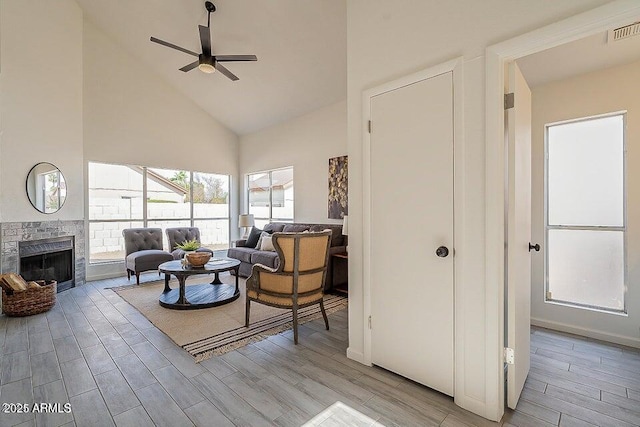 living room with high vaulted ceiling, a brick fireplace, and ceiling fan