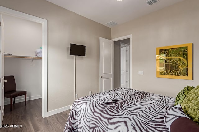 bedroom with dark hardwood / wood-style floors