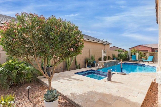 view of swimming pool with a patio area and an in ground hot tub