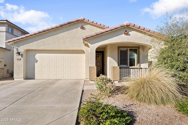 mediterranean / spanish-style house featuring a garage, driveway, a tiled roof, and stucco siding