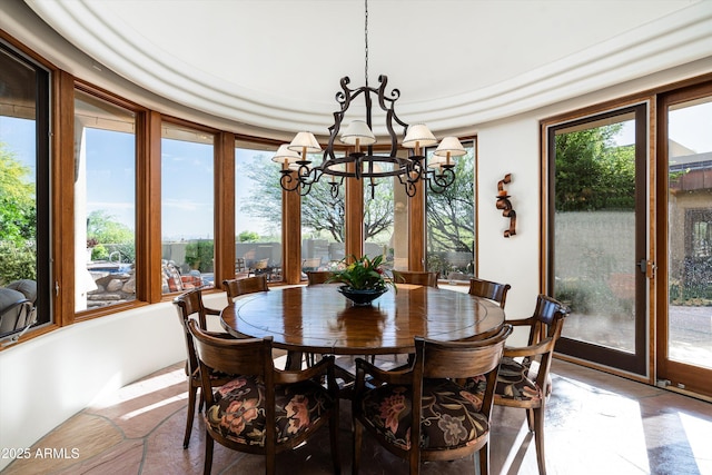 dining space featuring a notable chandelier