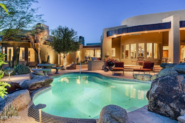 outdoor pool with a patio area