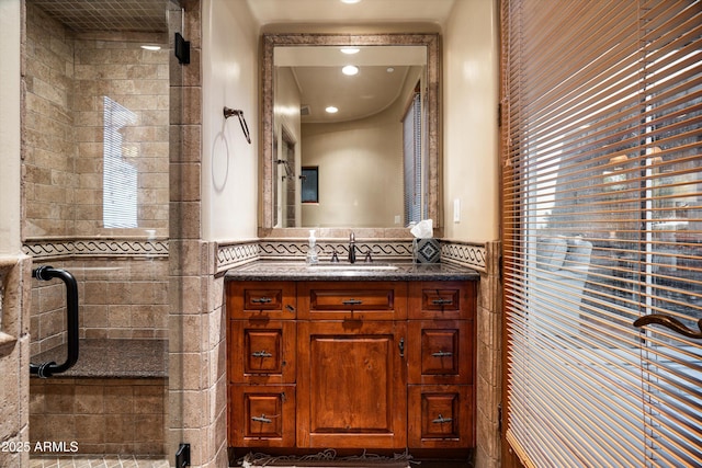 bathroom featuring vanity and a shower stall