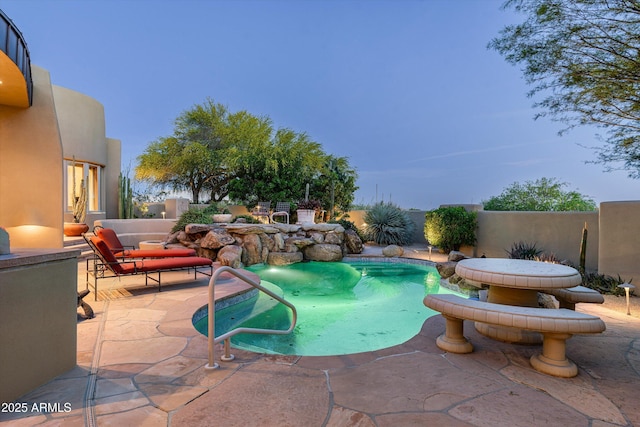 view of swimming pool featuring a fenced in pool, fence, and a patio area