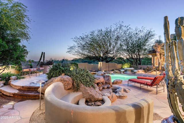 view of patio with a fenced in pool and fence