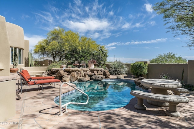 view of swimming pool featuring a fenced in pool, fence, and a patio