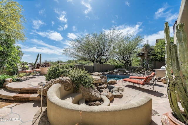 view of patio with a fenced in pool and fence