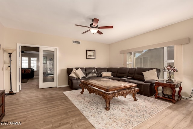 living room featuring french doors, ceiling fan, and wood-type flooring